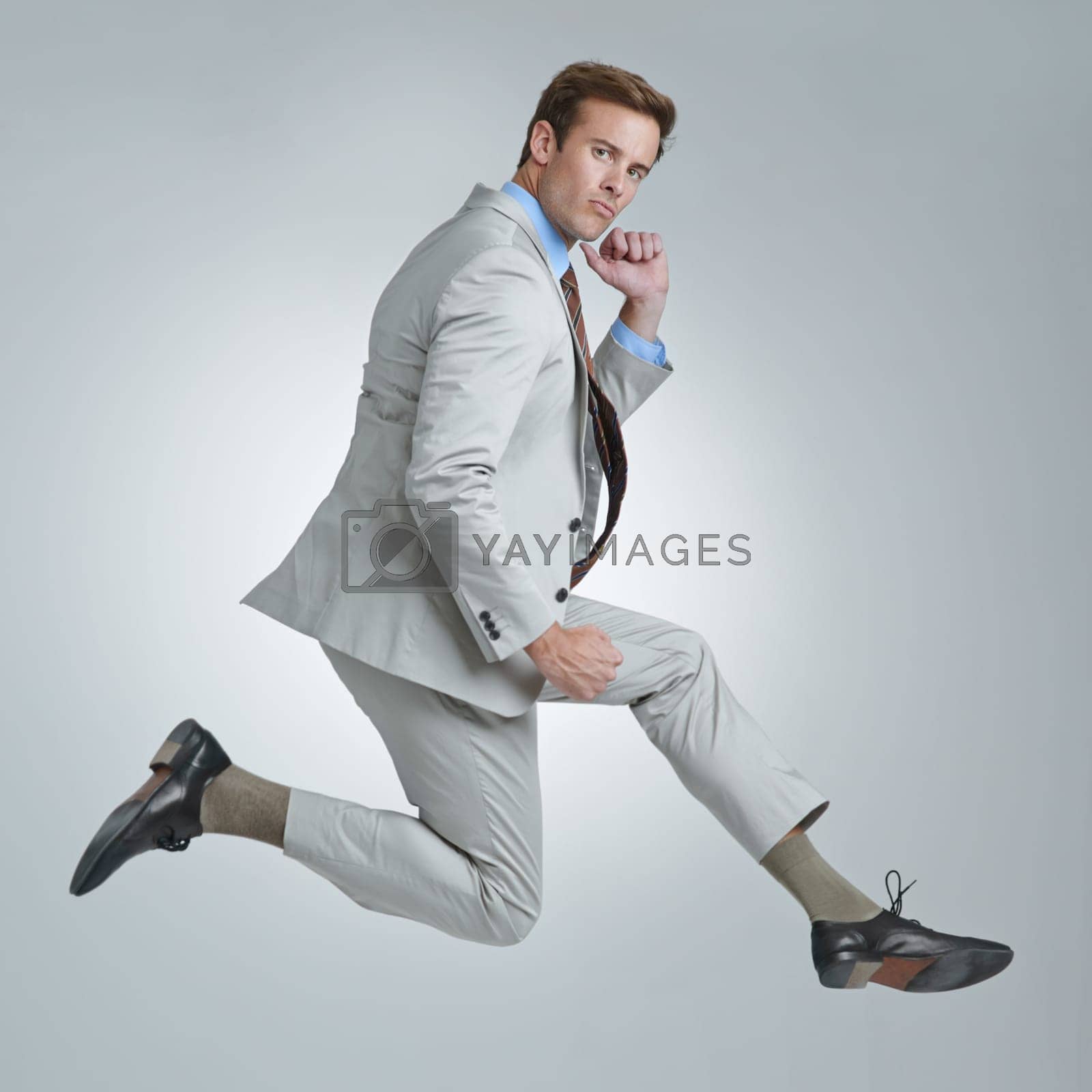 Royalty free image of Business ego. A young businessman wildly celebrating his success. by YuriArcurs