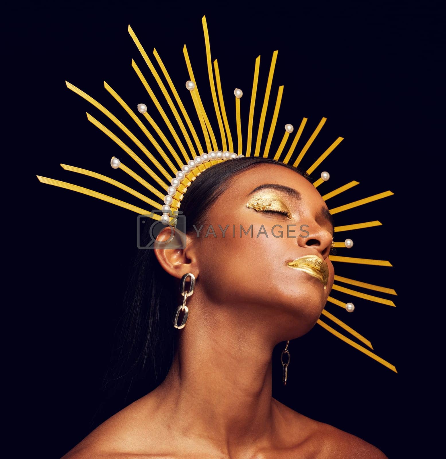 Royalty free image of Crown, gold makeup and a beauty queen isolated on a black background in a studio. Dreaming. ethereal and an Indian girl with cosmetics, accessories and jewelry for royalty on a dark backdrop by YuriArcurs