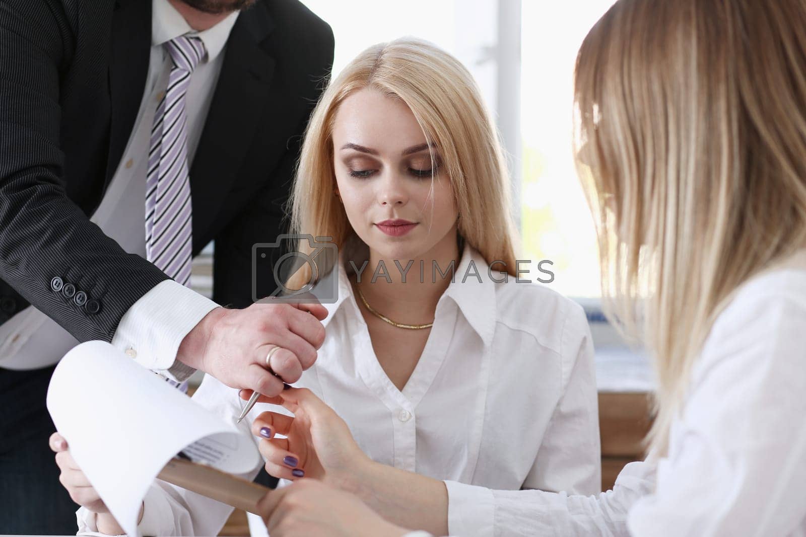Royalty free image of Beautiful woman portrait at workplace examining by kuprevich