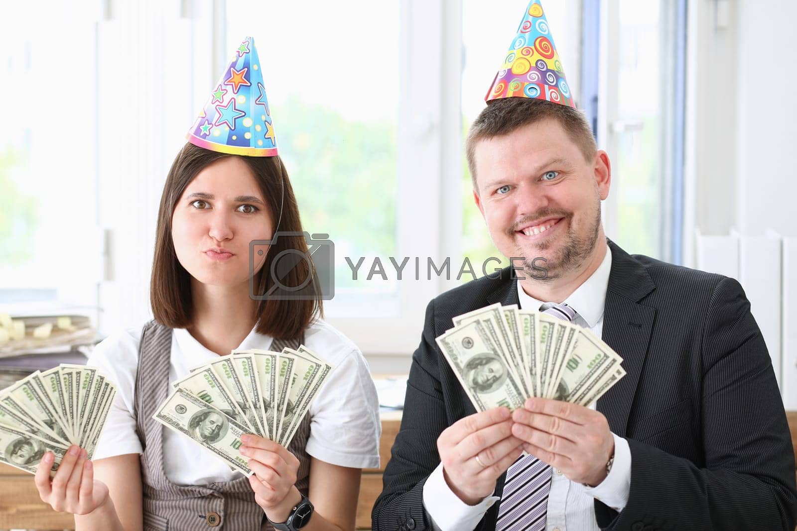 Royalty free image of A man and a woman enjoy light money by kuprevich