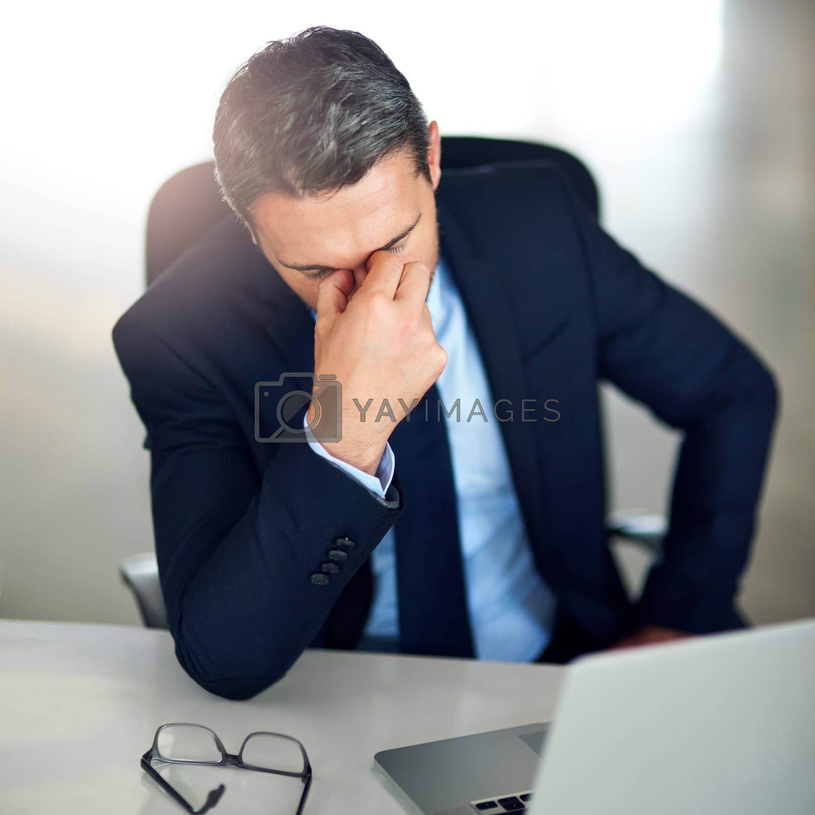 Royalty free image of Zero motivation. a businessman experiencing stress at the office. by YuriArcurs