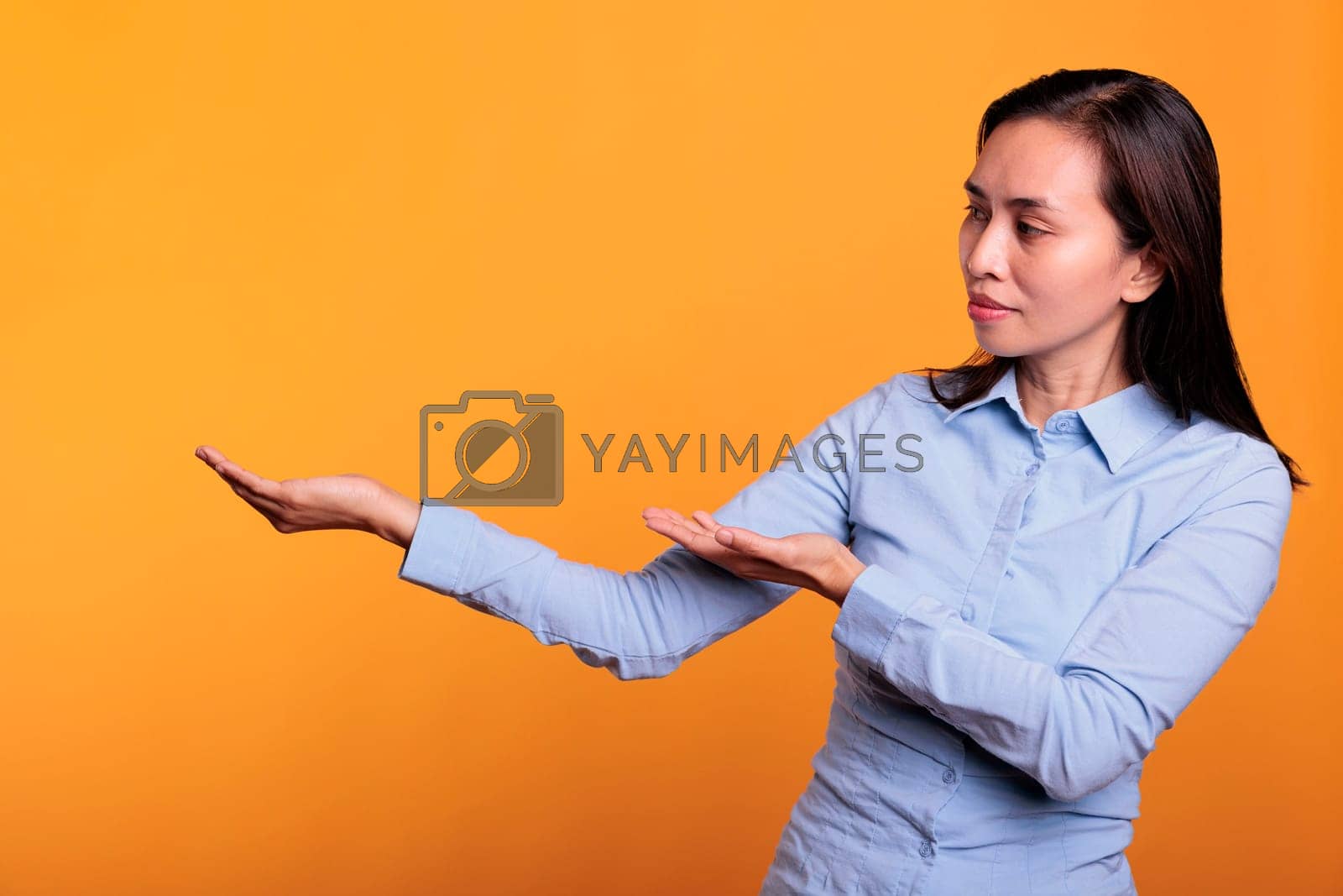 Royalty free image of Filipino model pointing at presentation icon on camera by DCStudio