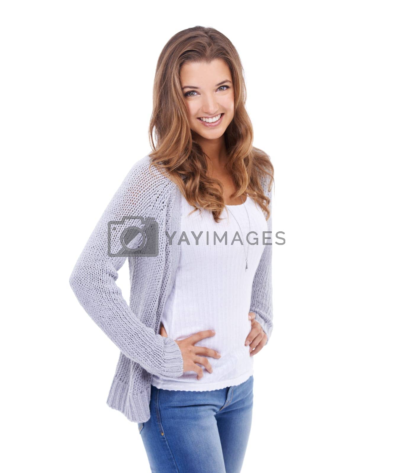 Royalty free image of Beauty in blue jeans. A young woman in casual wear standing against a white background and smiling at the camera. by YuriArcurs