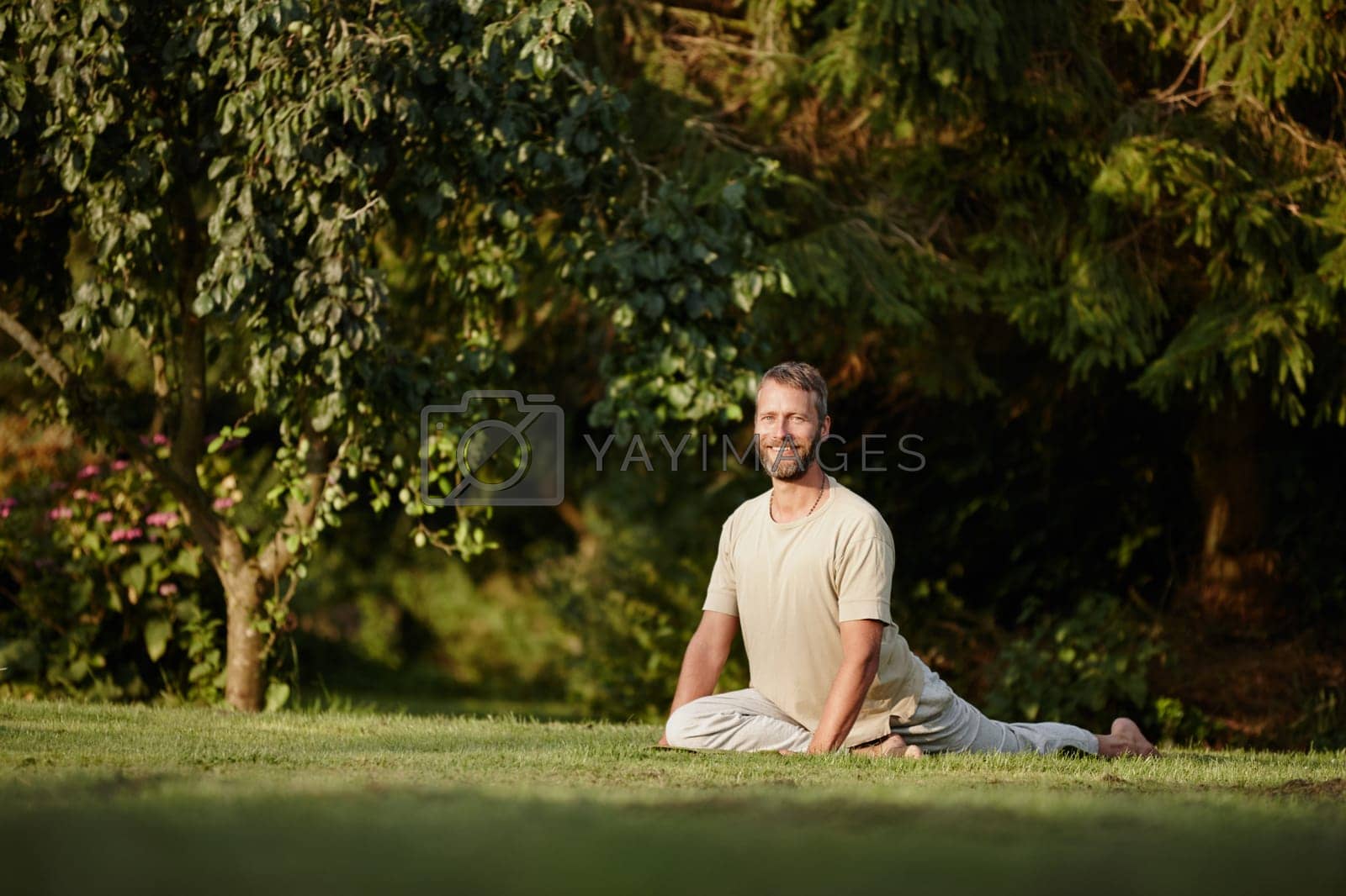 Royalty free image of Happiness is here and now. Full length portrait of a handsome mature man doing yoga in the outdoors. by YuriArcurs
