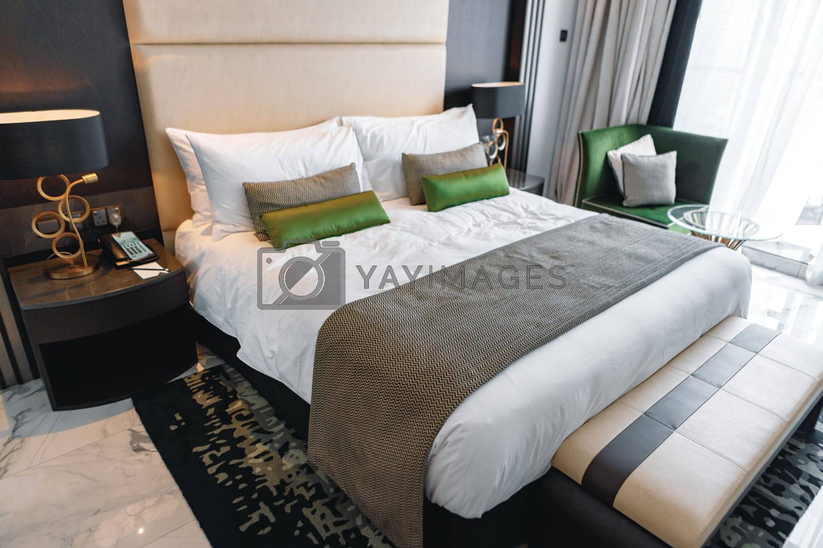 Royalty free image of Modern bedroom with bed in a hotel by Fabrikasimf