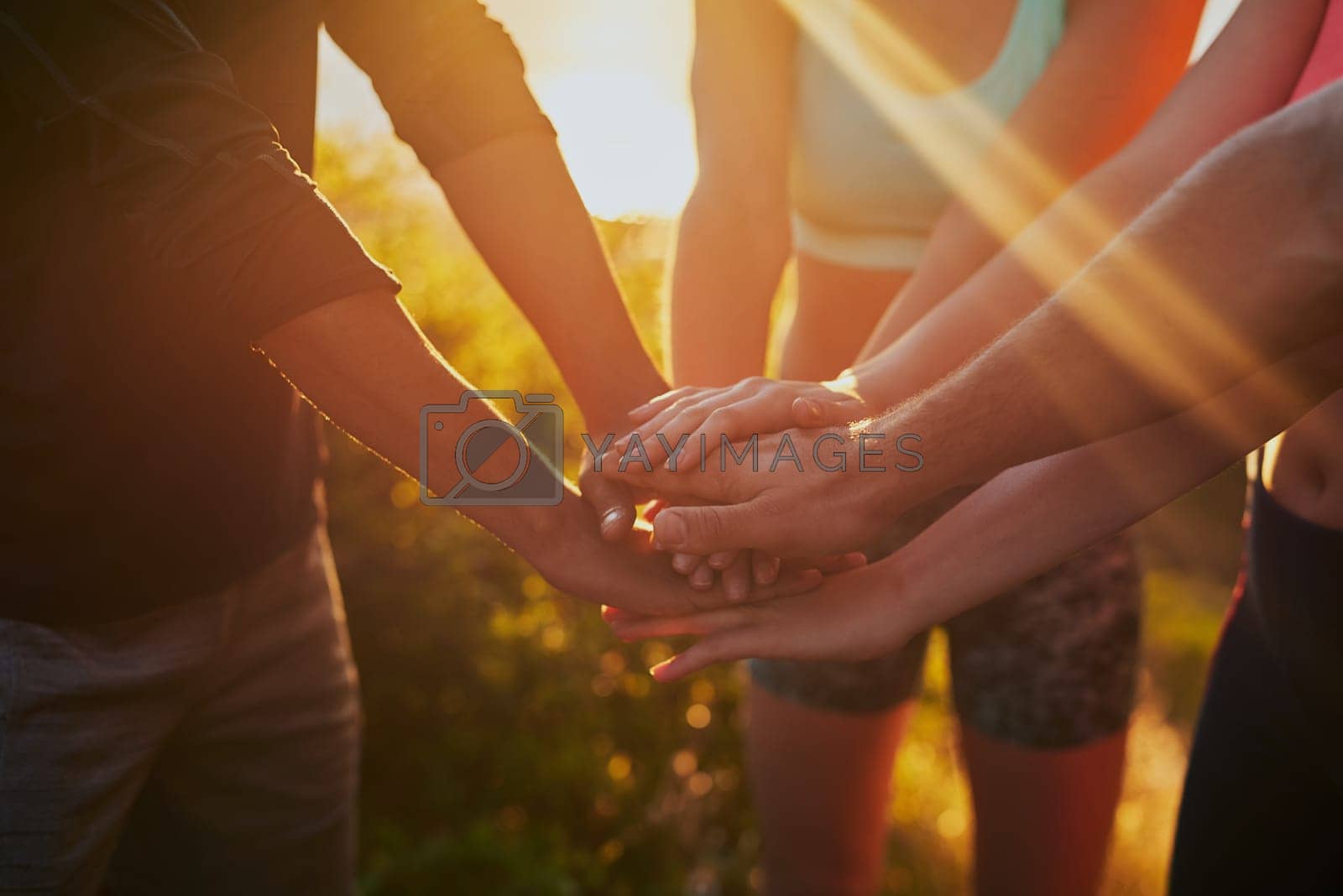 Royalty free image of Hands together, fitness group and outdoor with motivation, workout and teamwork in nature. Exercise, sport and people with hand in sign for support, training and goal with solidarity and sun by YuriArcurs