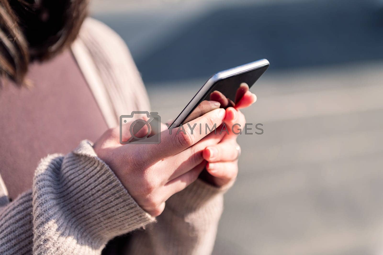Royalty free image of close up of hands of woman using mobile phone by raulmelldo