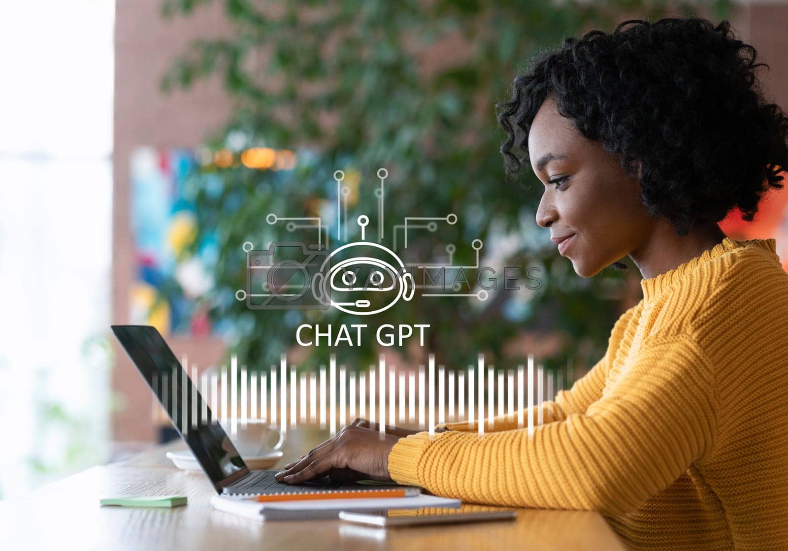 Royalty free image of Cheerful african american woman using chat gpt on laptop by Prostock-studio
