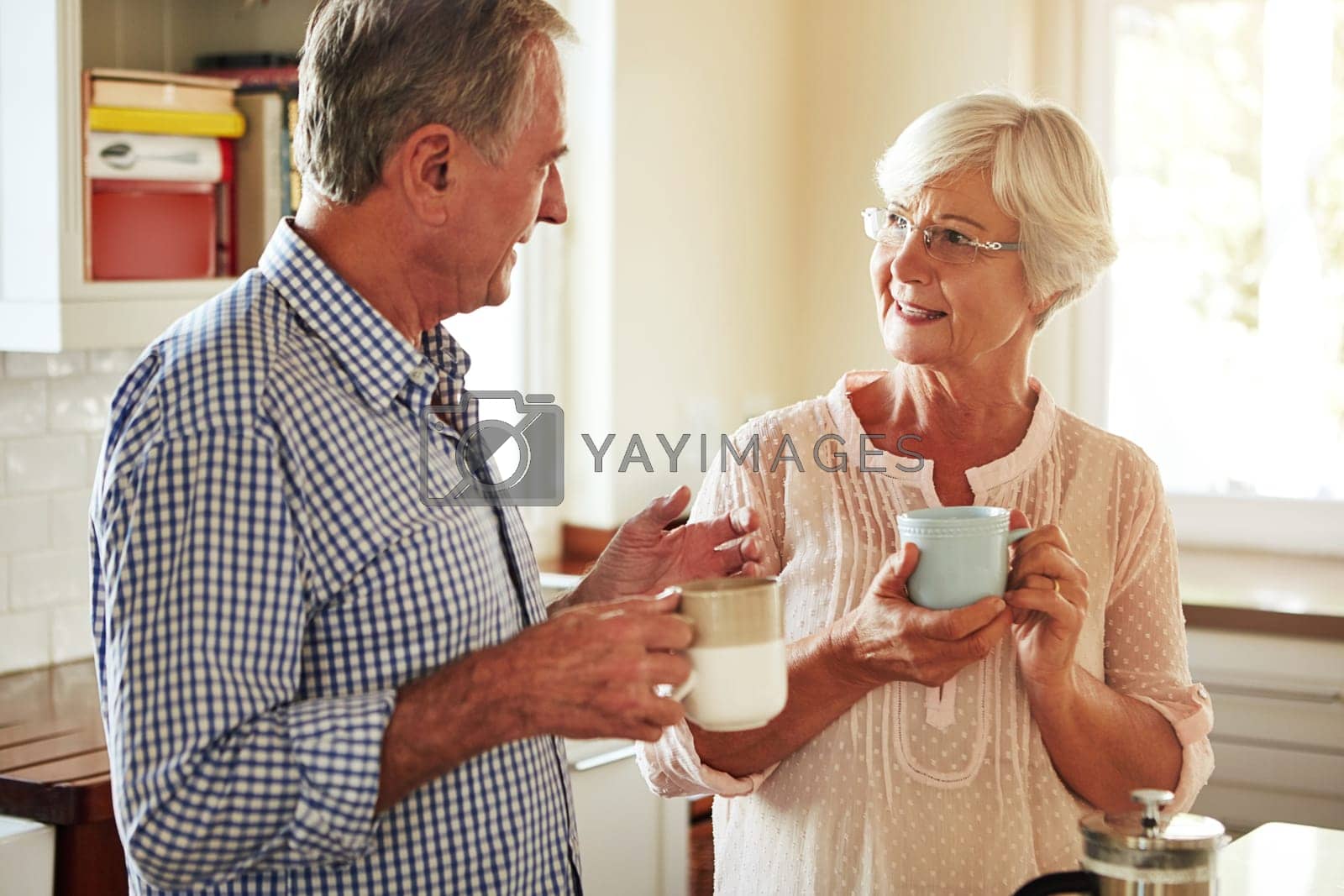 Royalty free image of Chat, coffee or old couple talking in kitchen at home bonding or enjoying quality morning time together. Happy, retirement or senior man speaking, relaxing or drinking tea espresso with woman at home by YuriArcurs