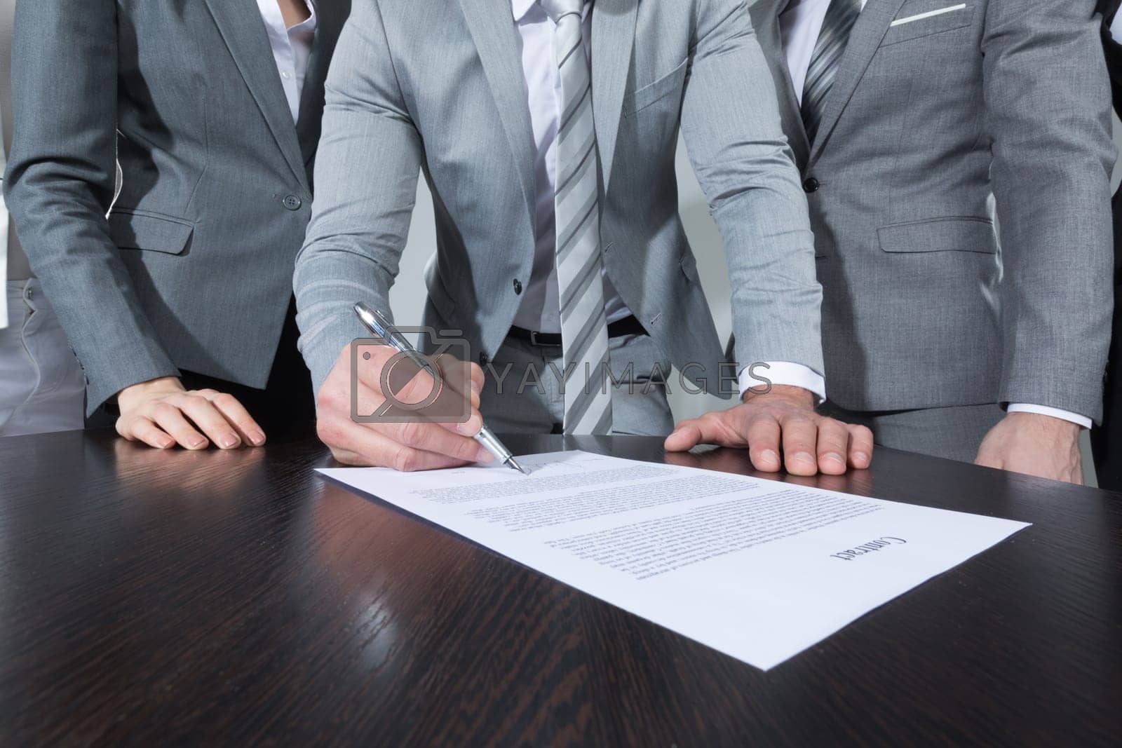 Royalty free image of Businessman signing contract by Yellowj