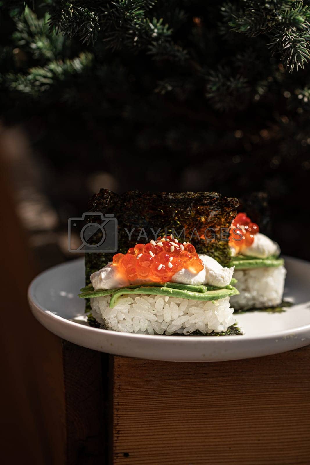Royalty free image of Japanese hand rolls with caviar and avocado by Hihitetlin