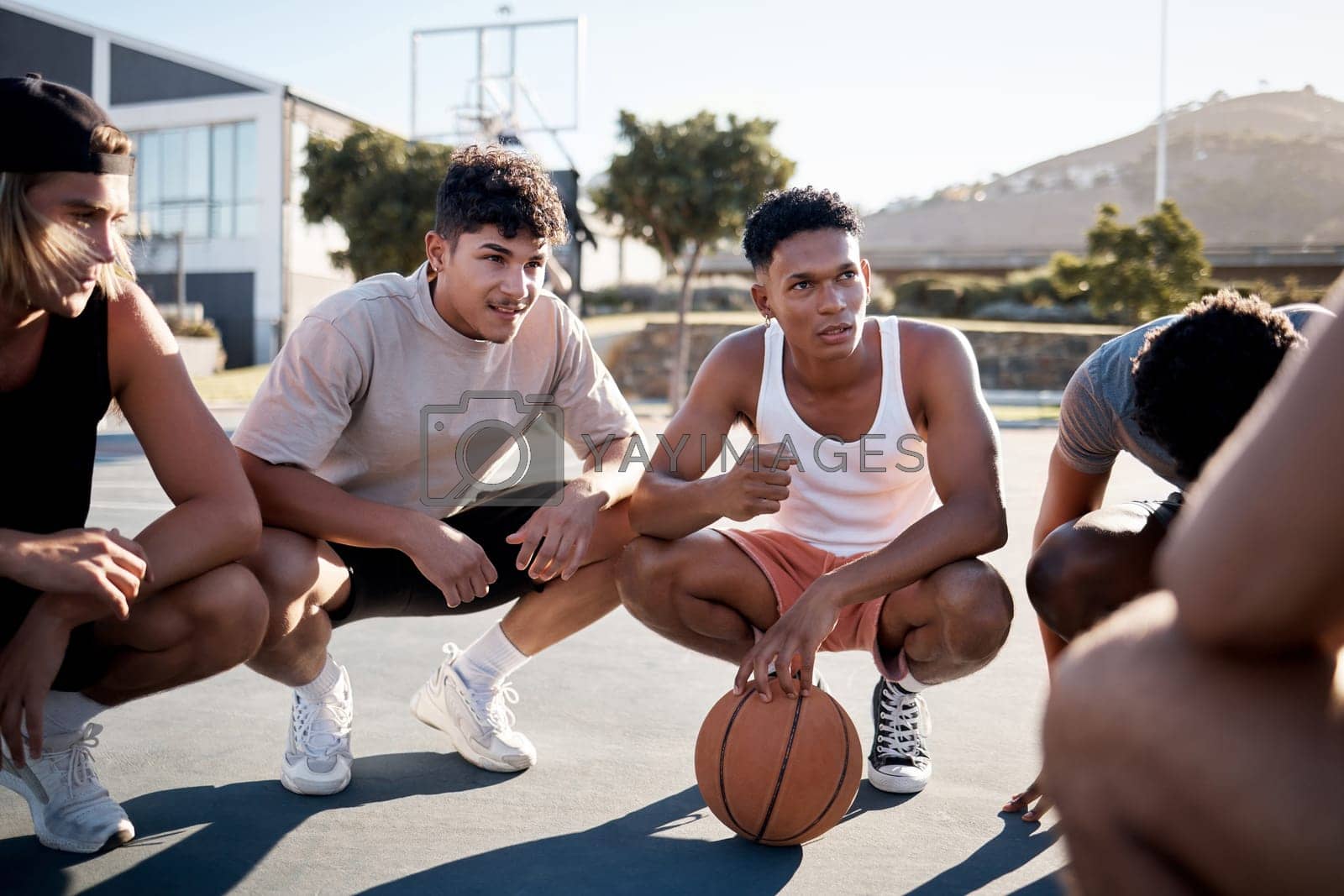 Royalty free image of Basketball, team and meeting in game discussion for strategy, planning or collaboration on the court. Group of sports men talking in teamwork, conversation or match plan together in the outdoors by YuriArcurs