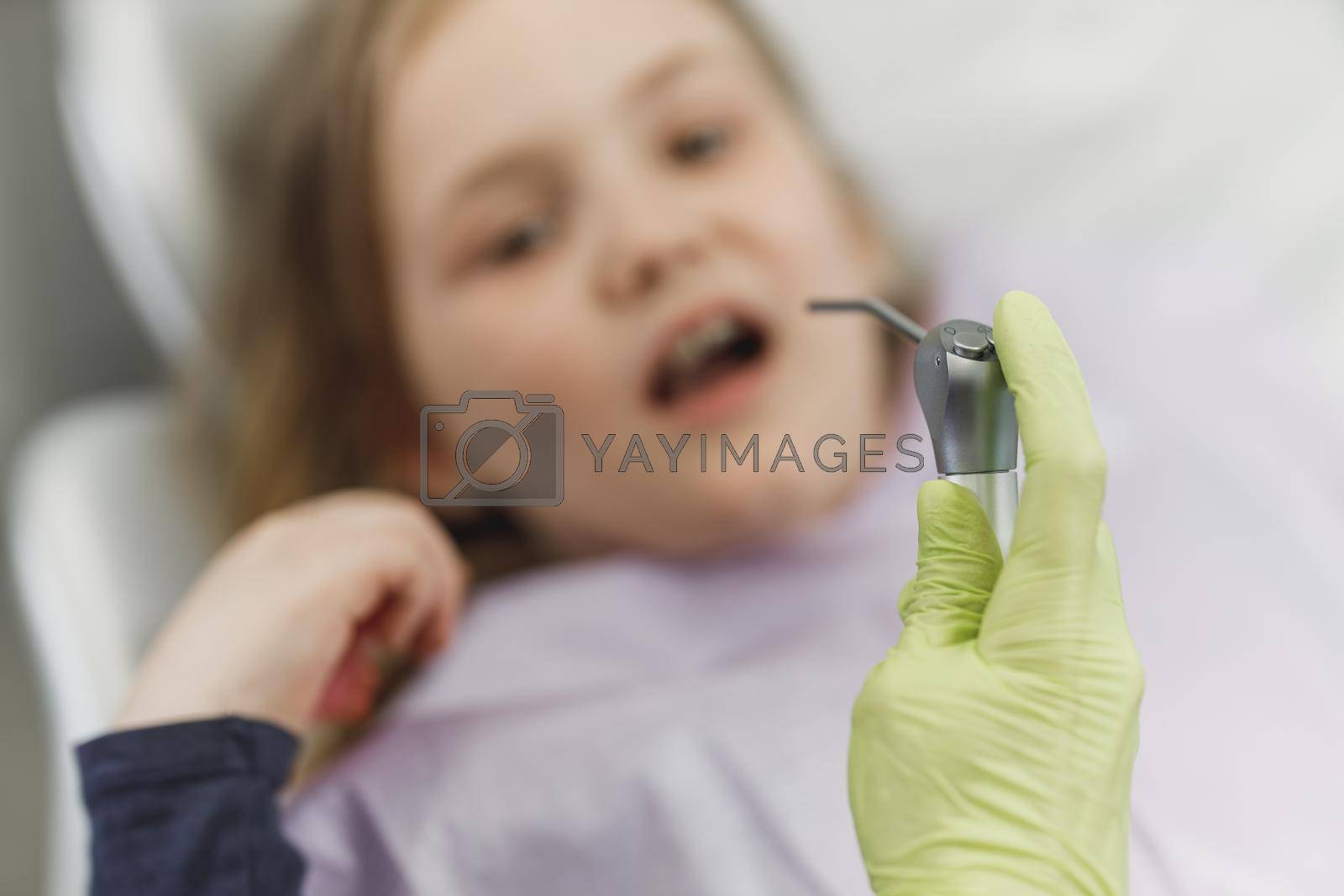 Close-up of dentist preparing for dental examination of a child.