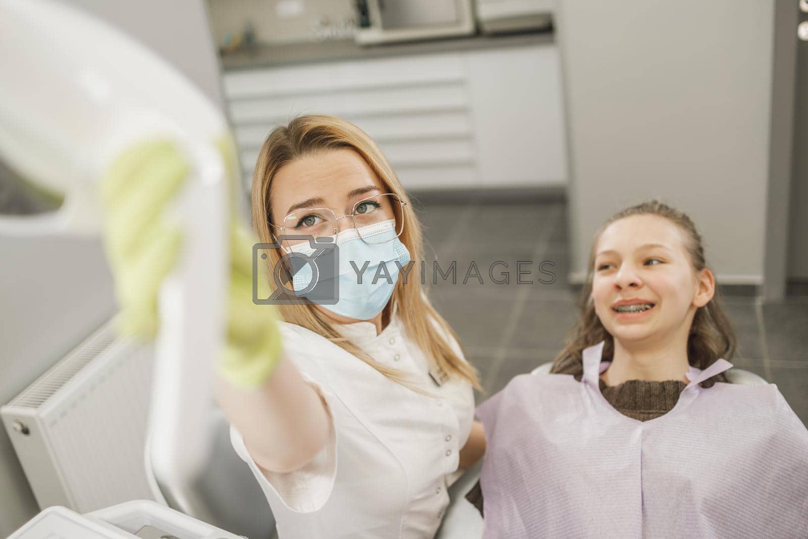 Shot of a teenager girl having a consultation with her dentist.
