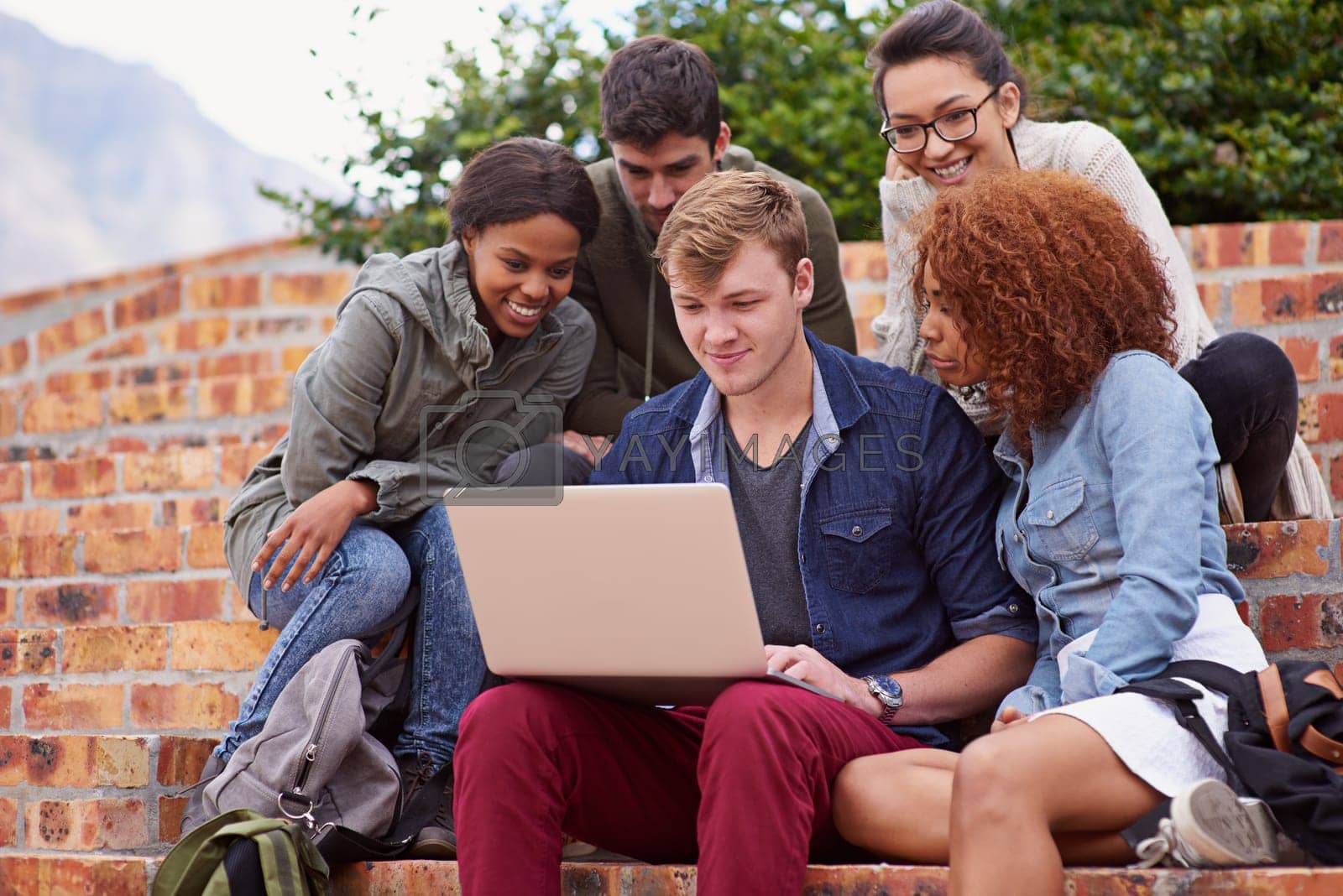 Royalty free image of Laptop, university students and group studying, teamwork and planning schedule, project ideas or collaboration. Happy diversity people, youth or friends on college campus steps for online education by YuriArcurs