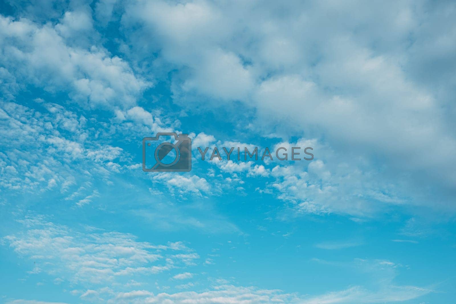 Royalty free image of Beautiful white fluffys clouds sky background with blue sky background by Petrichor