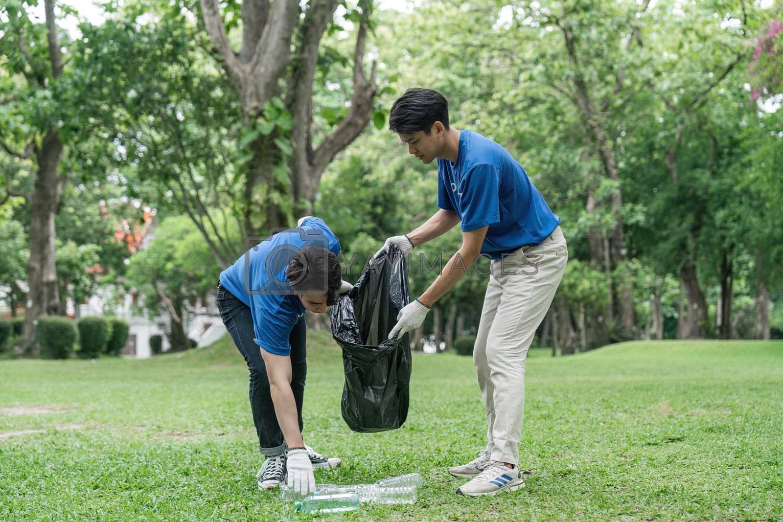 Royalty free image of volunteering, charity, cleaning, young and ecology concept group of happy volunteers with garbage bags cleaning area by nateemee