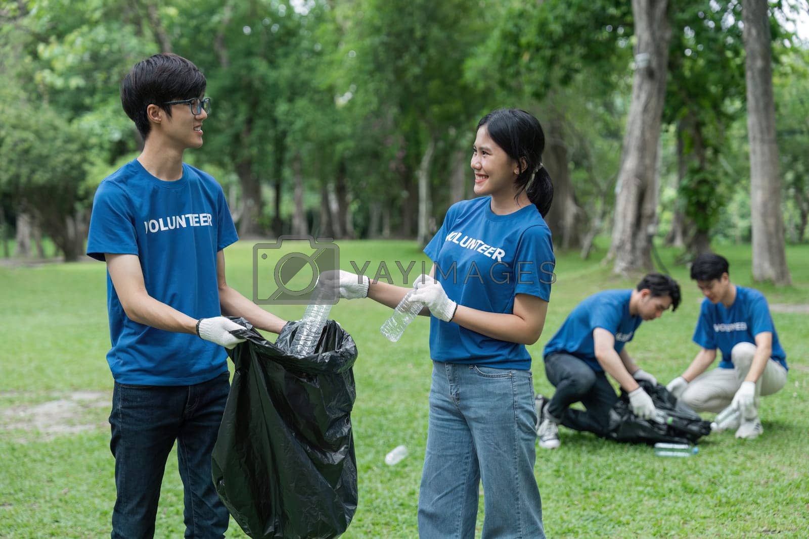Royalty free image of Volunteers collect litter, teenager smiling, environmental and ecological care by nateemee