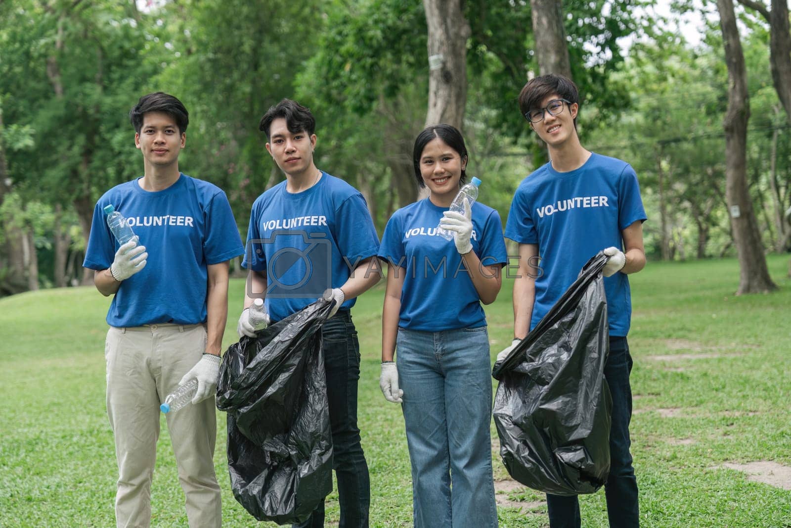 Royalty free image of Team volunteers collecting garbage in public park. Environmental protection Concept by nateemee