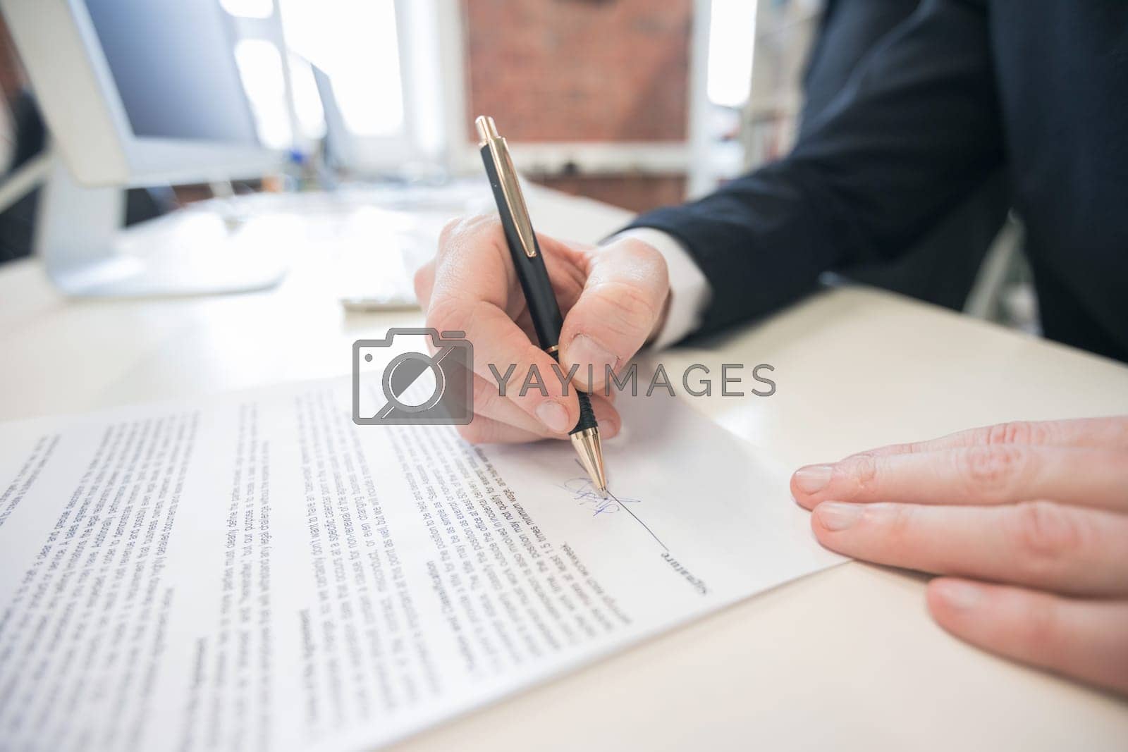 Royalty free image of Businessman signing a contract by Yellowj
