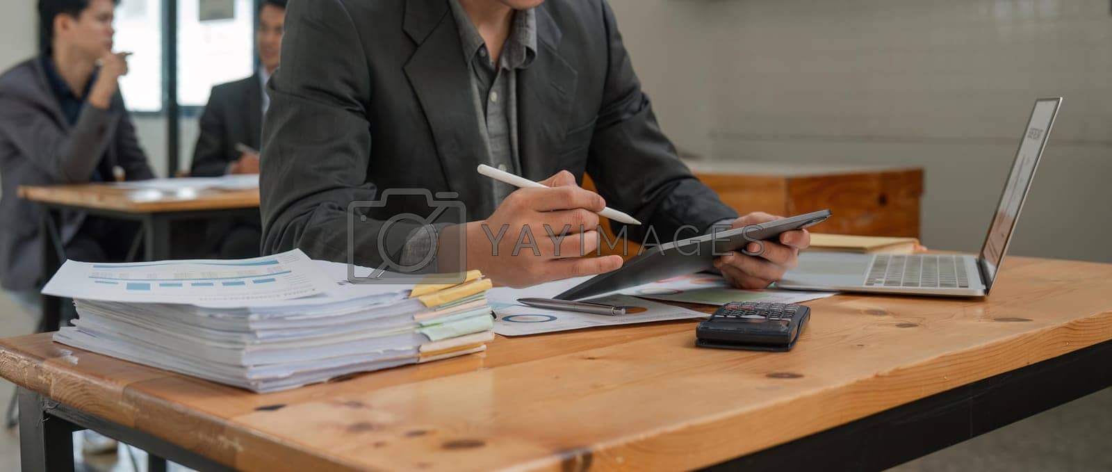 Royalty free image of Business accounting concept, Business man using calculator with computer laptop and tablet in office by nateemee