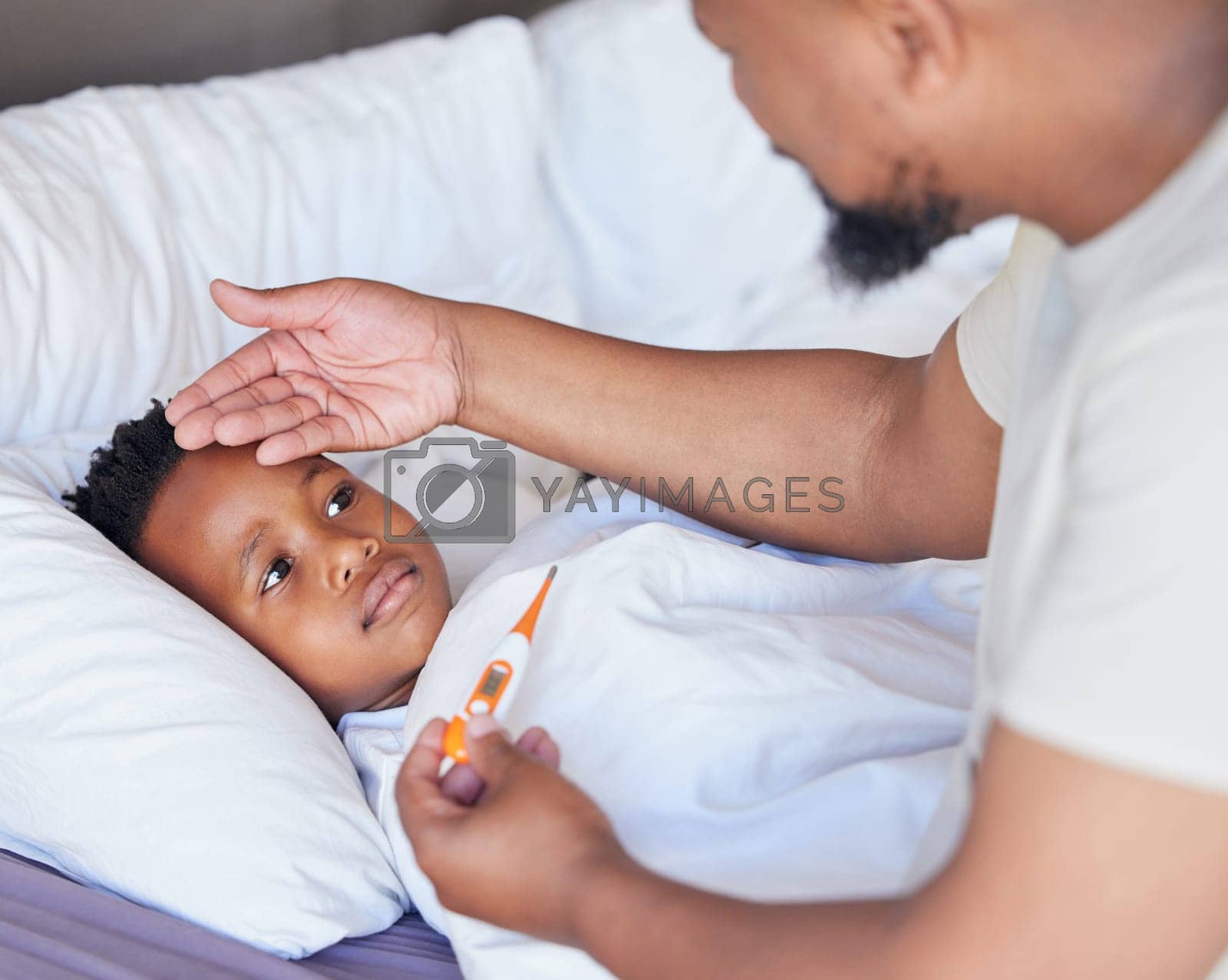 Royalty free image of Father, thermometer and sick child in bed with a fever and hand of dad on head to check temperature. Black boy kid and a man together in a bedroom for medical risk, health test and virus problem by YuriArcurs