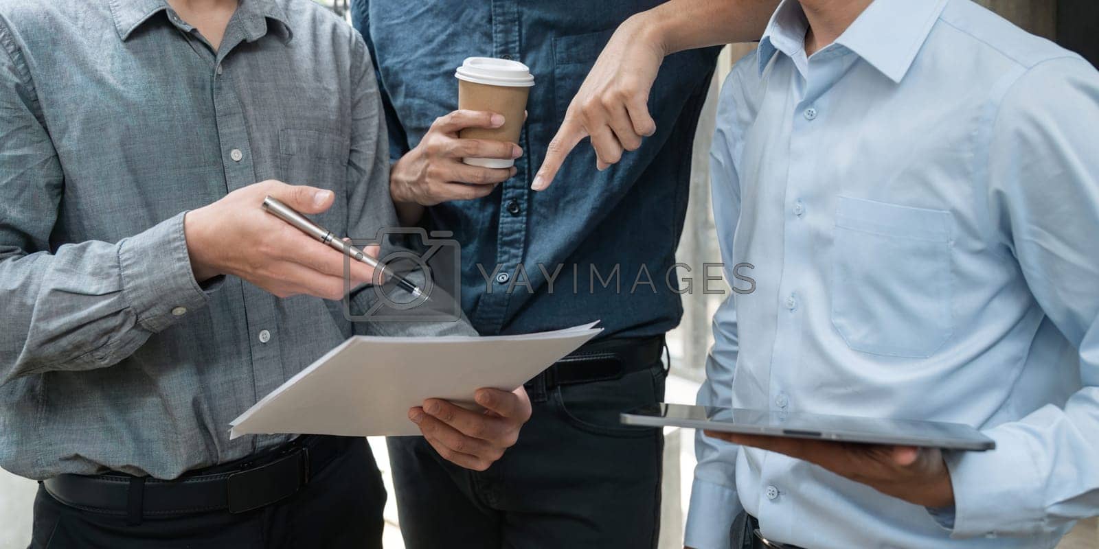 Royalty free image of Group of young Asian business people stand talk, consult, discuss working with new startup project idea presentation analyze plan marketing and investment by nateemee