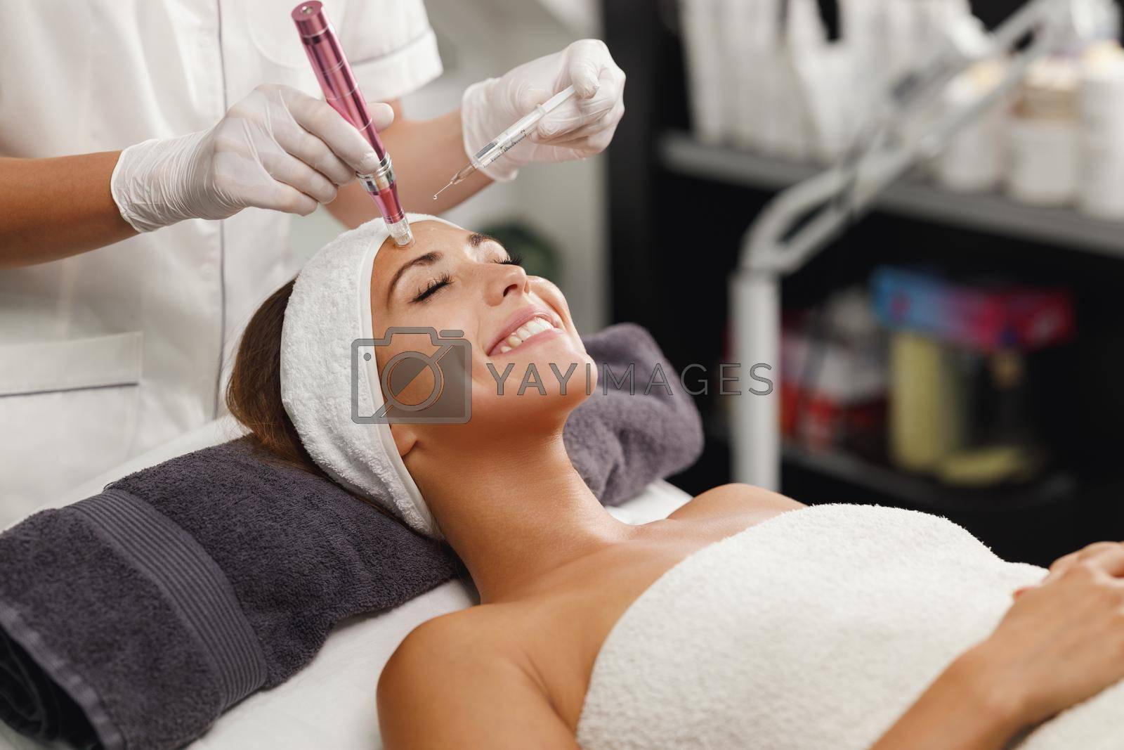 Royalty free image of Dermapen Micro-needling Treatment In A Beauty Salon by MilanMarkovic78