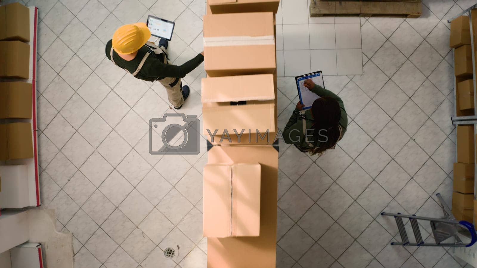 Royalty free image of Warehouse coordinators examine parcels by DCStudio
