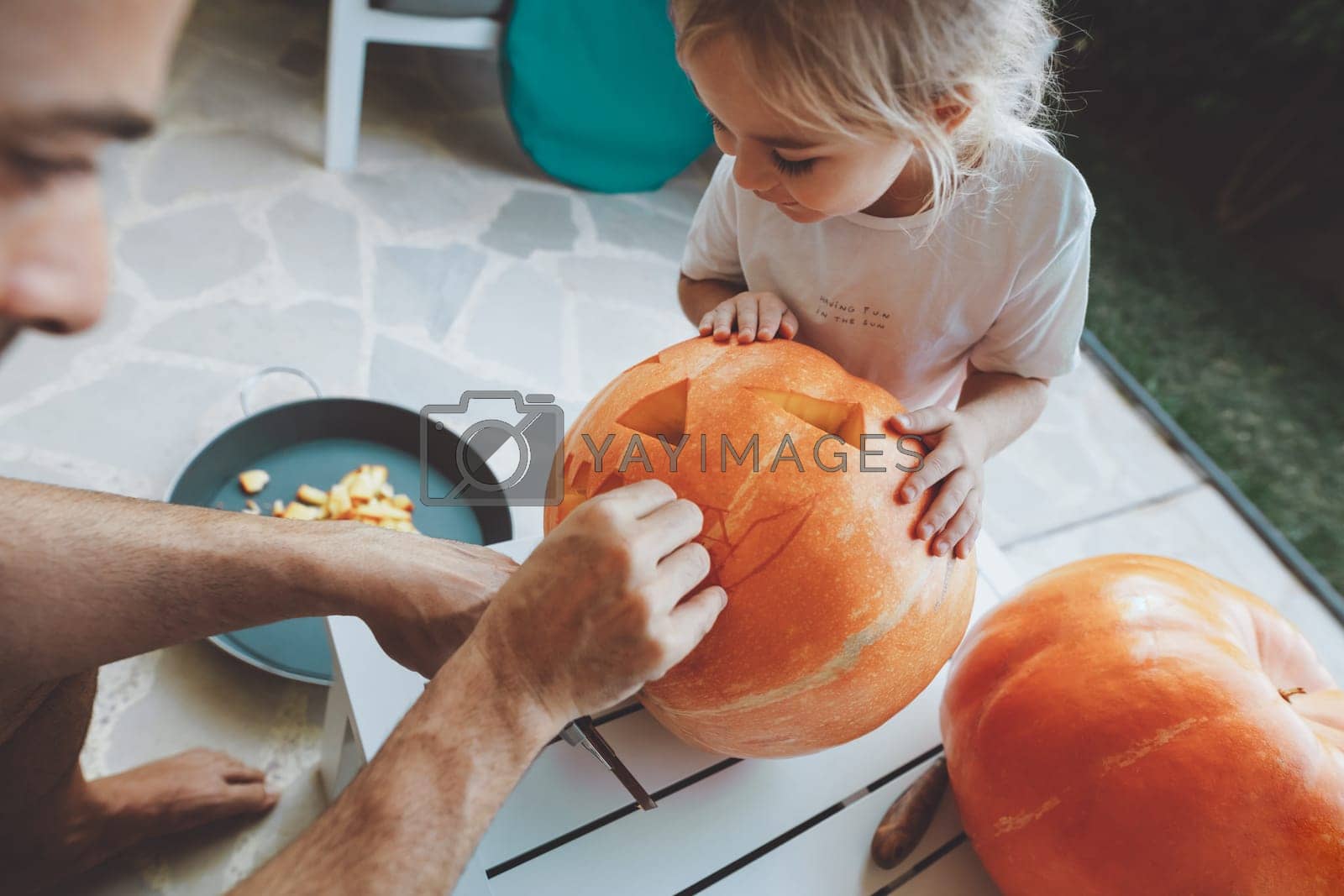 Royalty free image of Father and son carving the pumpkins by Anna_Omelchenko