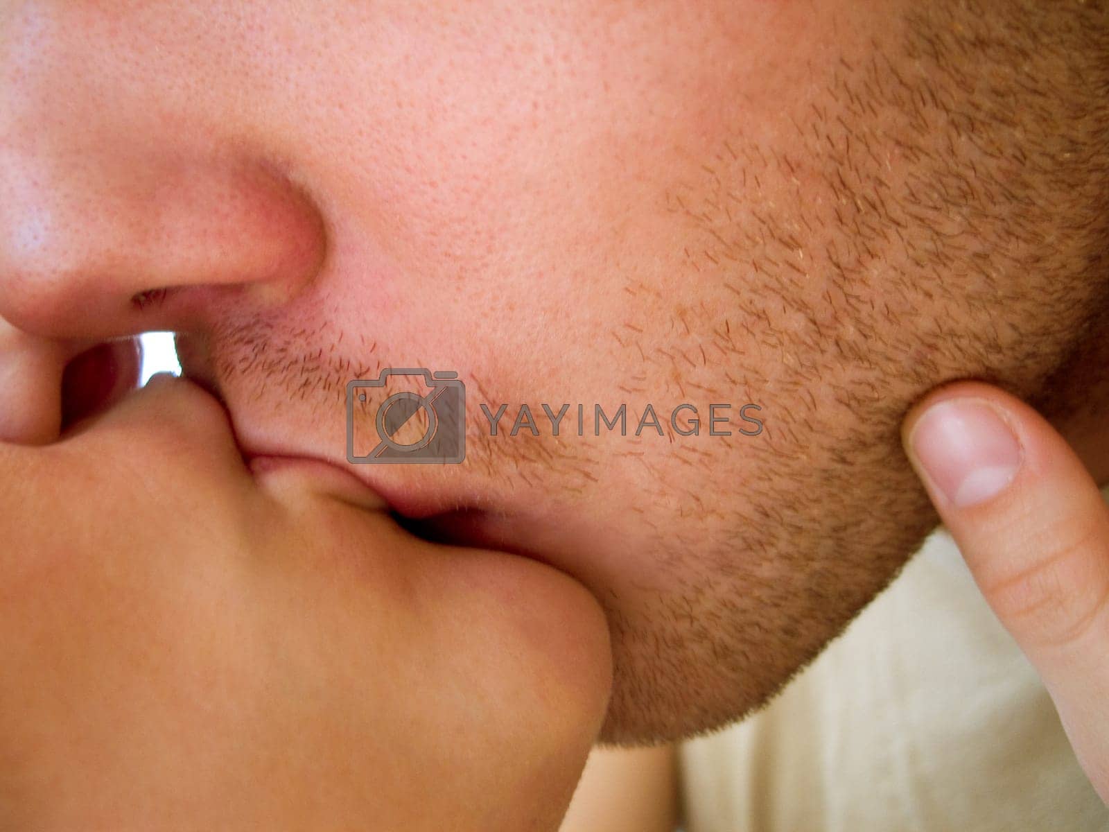 Royalty free image of Closeup, love and man with woman in kiss, desire and lips together with touch on face. Couple, intimate and relationship for passion on mouth, romance and caring partner with bonding or quality time by YuriArcurs