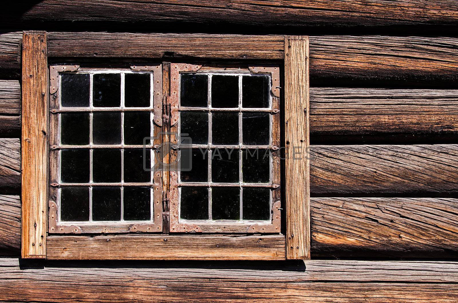Royalty free image of Weathered log house wall window by Nanisimova