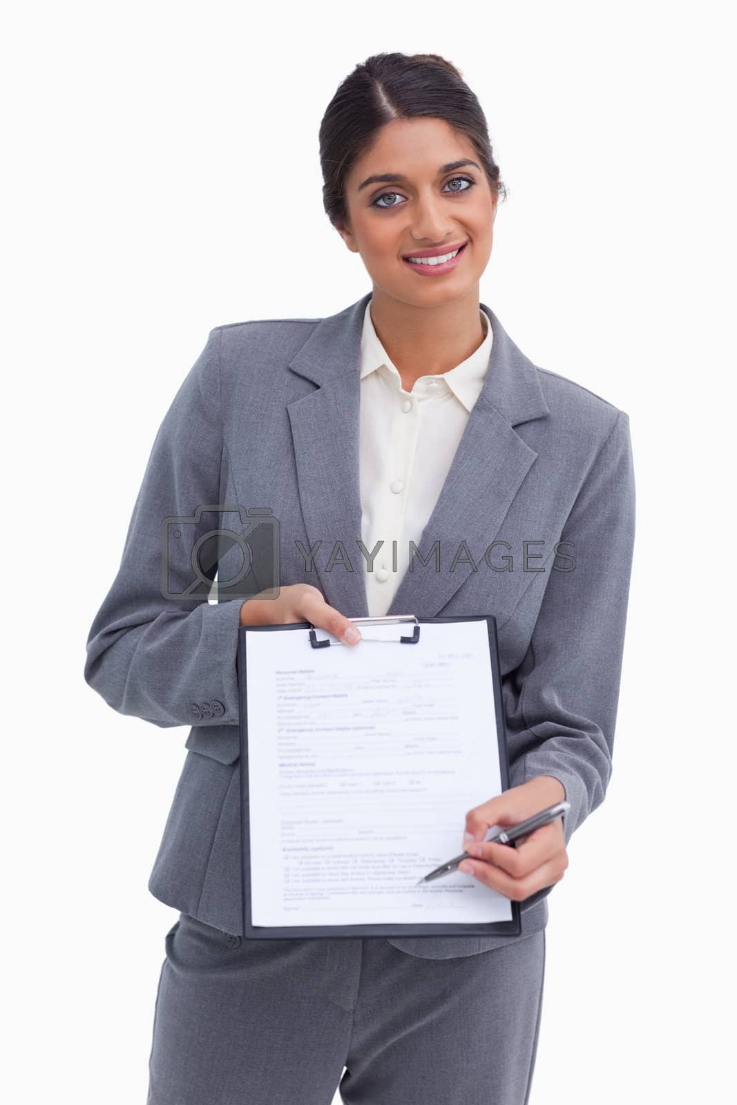 Royalty free image of Smiling female entrepreneur asking for signature by Wavebreakmedia