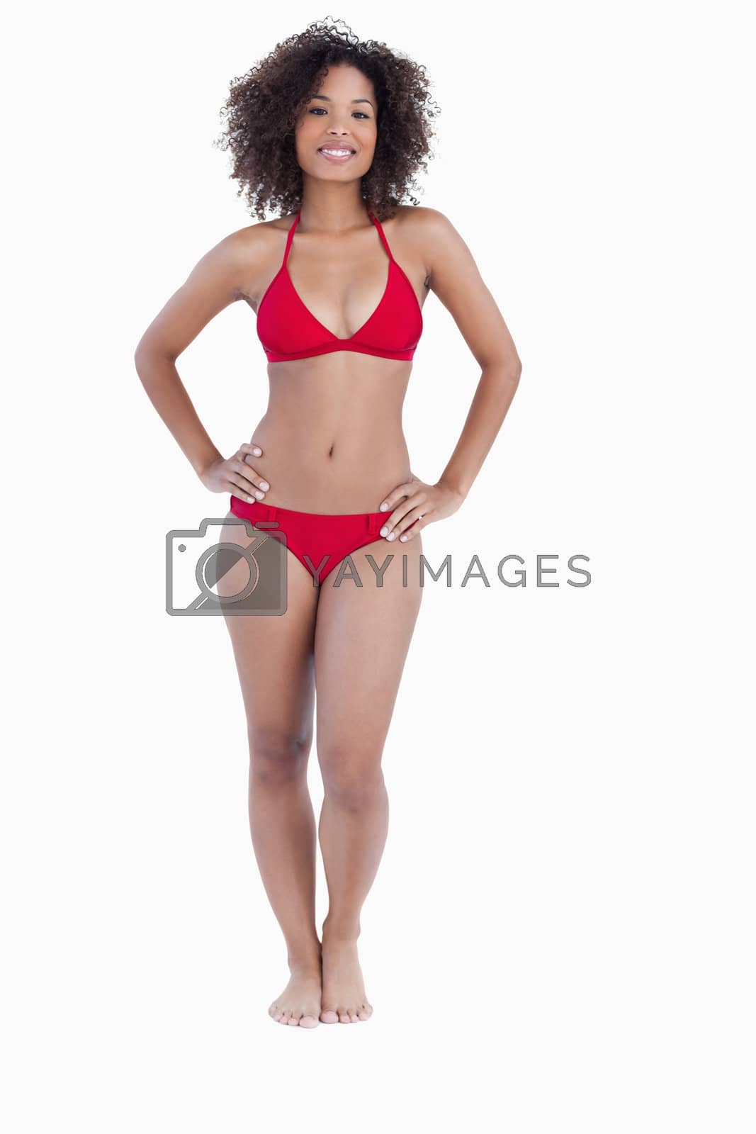 Royalty free image of Smiling woman standing upright in swimsuit by Wavebreakmedia