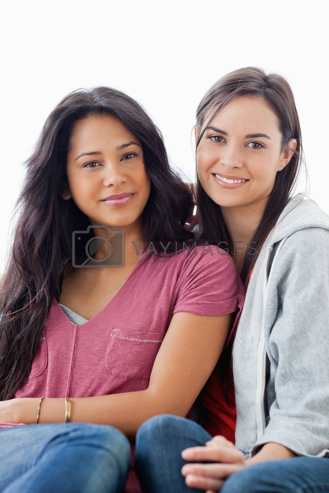 Royalty free image of Half length shot of two women lying against each other while loo by Wavebreakmedia