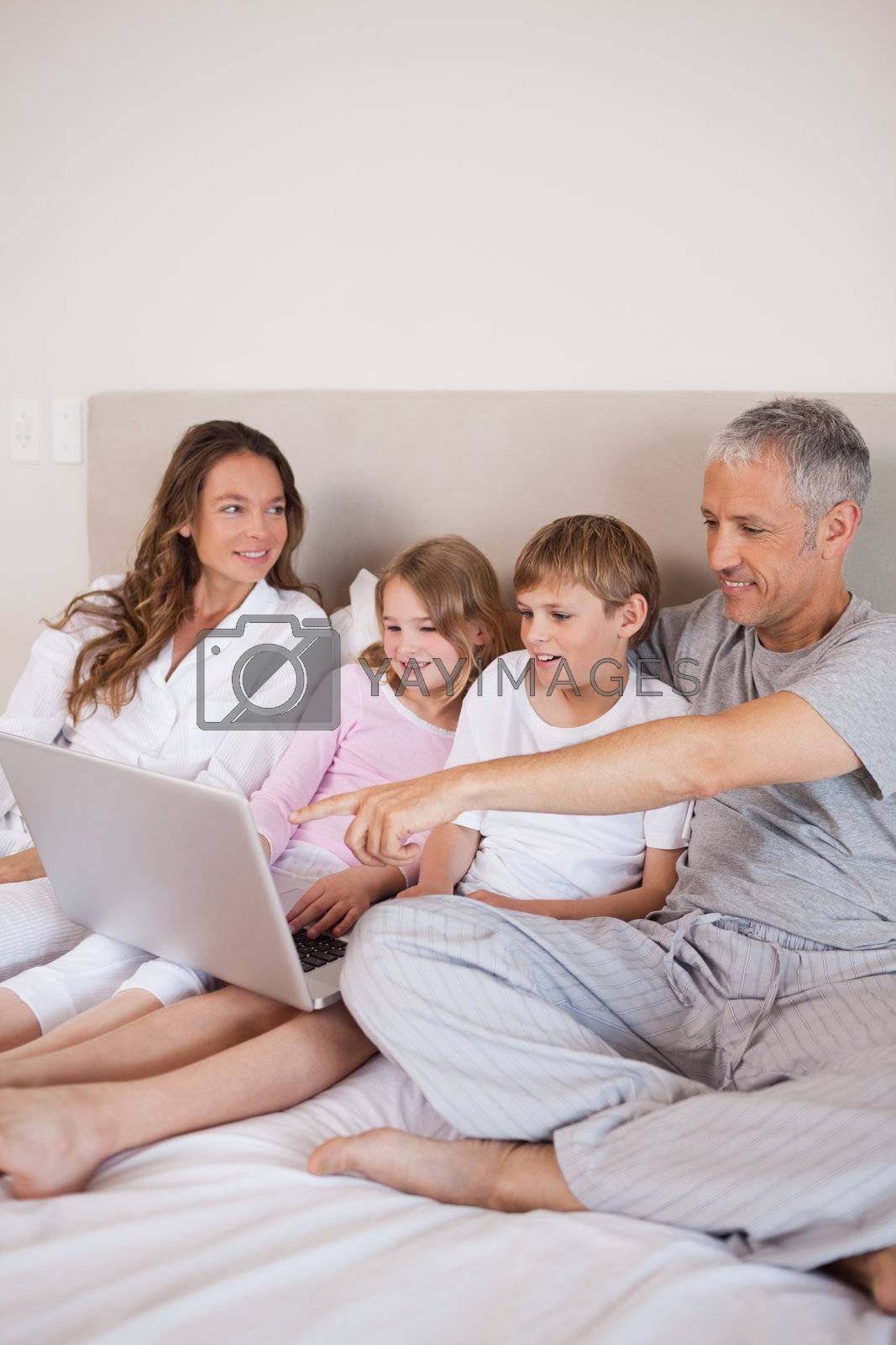 Royalty free image of Portrait of a family using a notebook by Wavebreakmedia