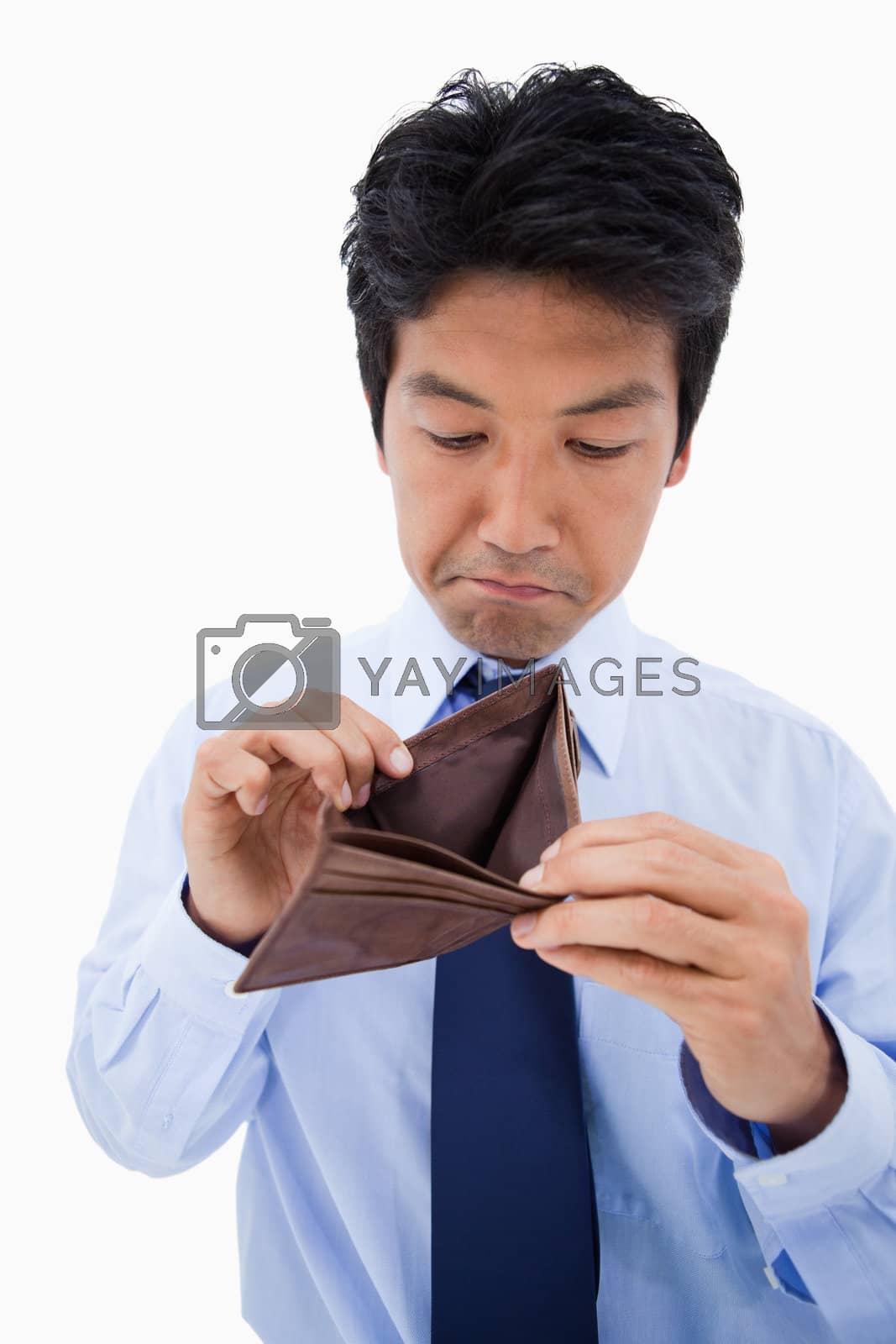 Royalty free image of Portrait of a sad businessman showing his empty wallet by Wavebreakmedia