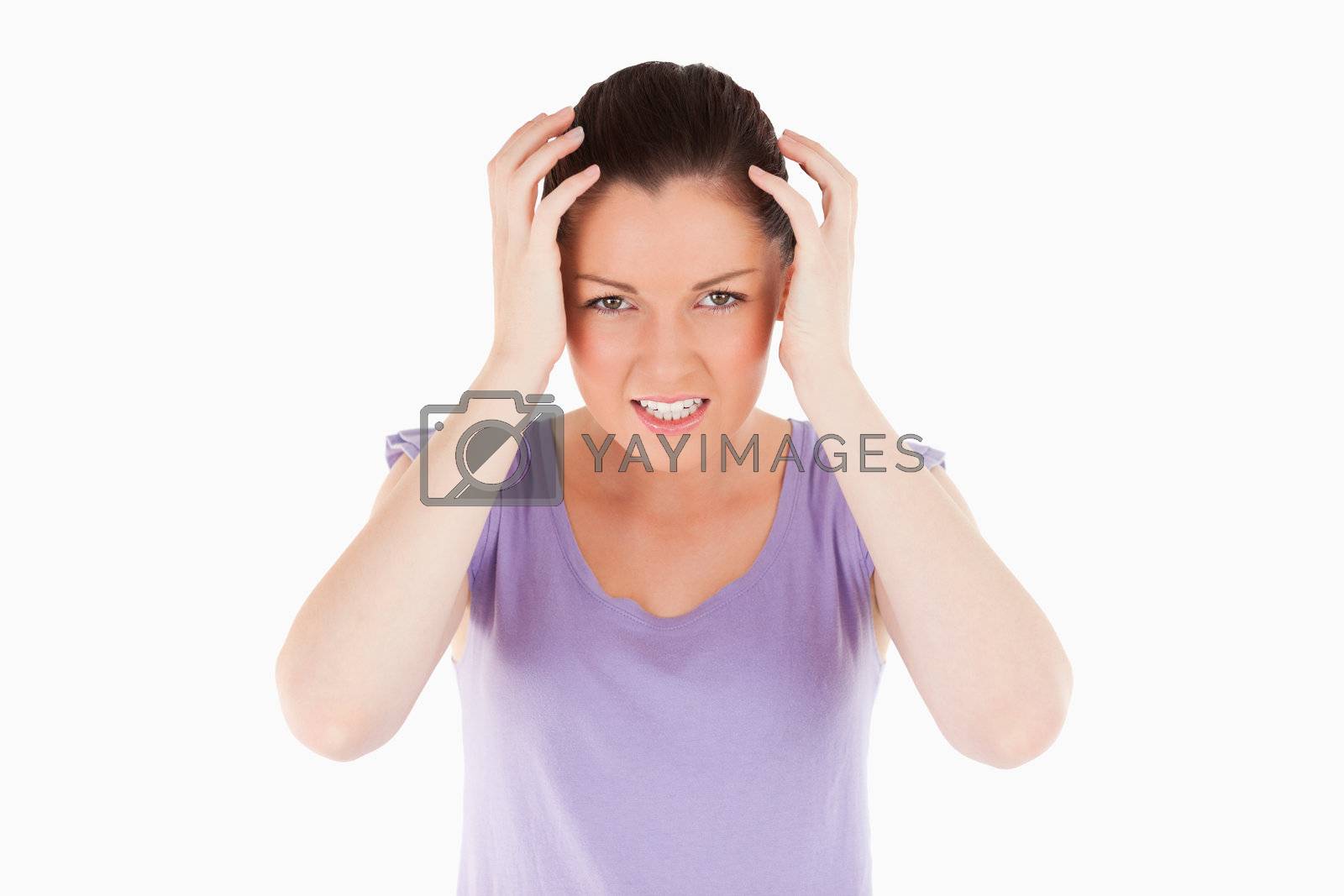 Royalty free image of Attractive woman having a migraine while standing by Wavebreakmedia