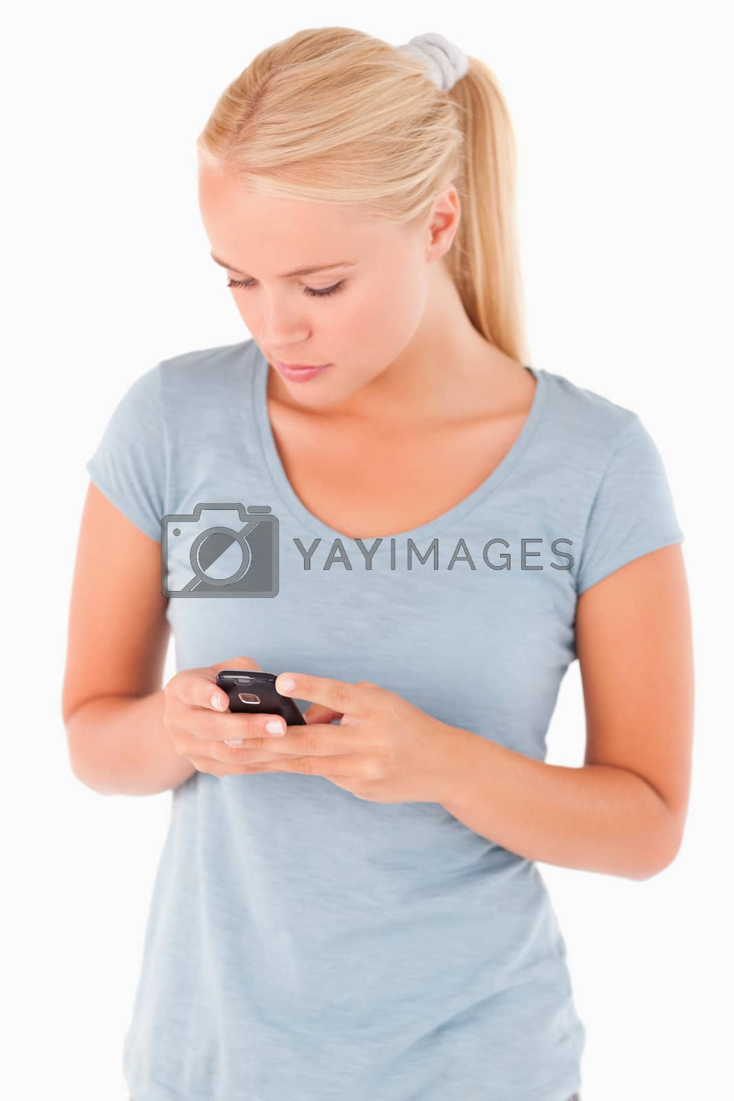 Royalty free image of Cute Woman dialing on a phone by Wavebreakmedia