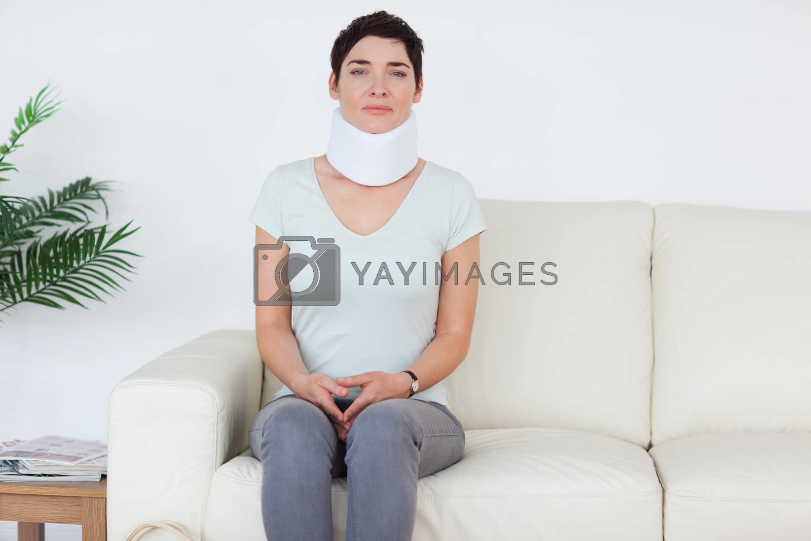Royalty free image of Sad Woman with a surgical collar by Wavebreakmedia