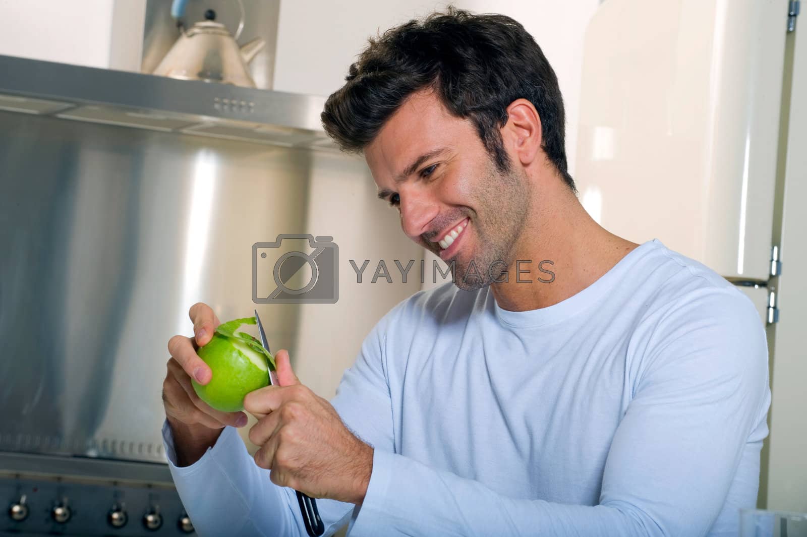 Royalty free image of man peeling an apple by ambro