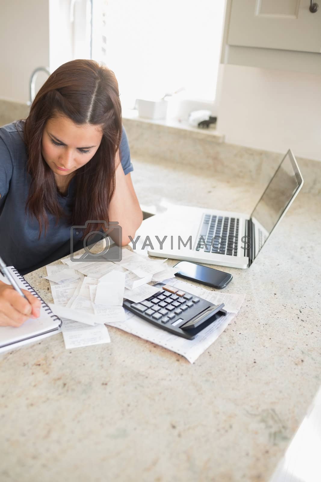 Royalty free image of Woman calculating finances by Wavebreakmedia