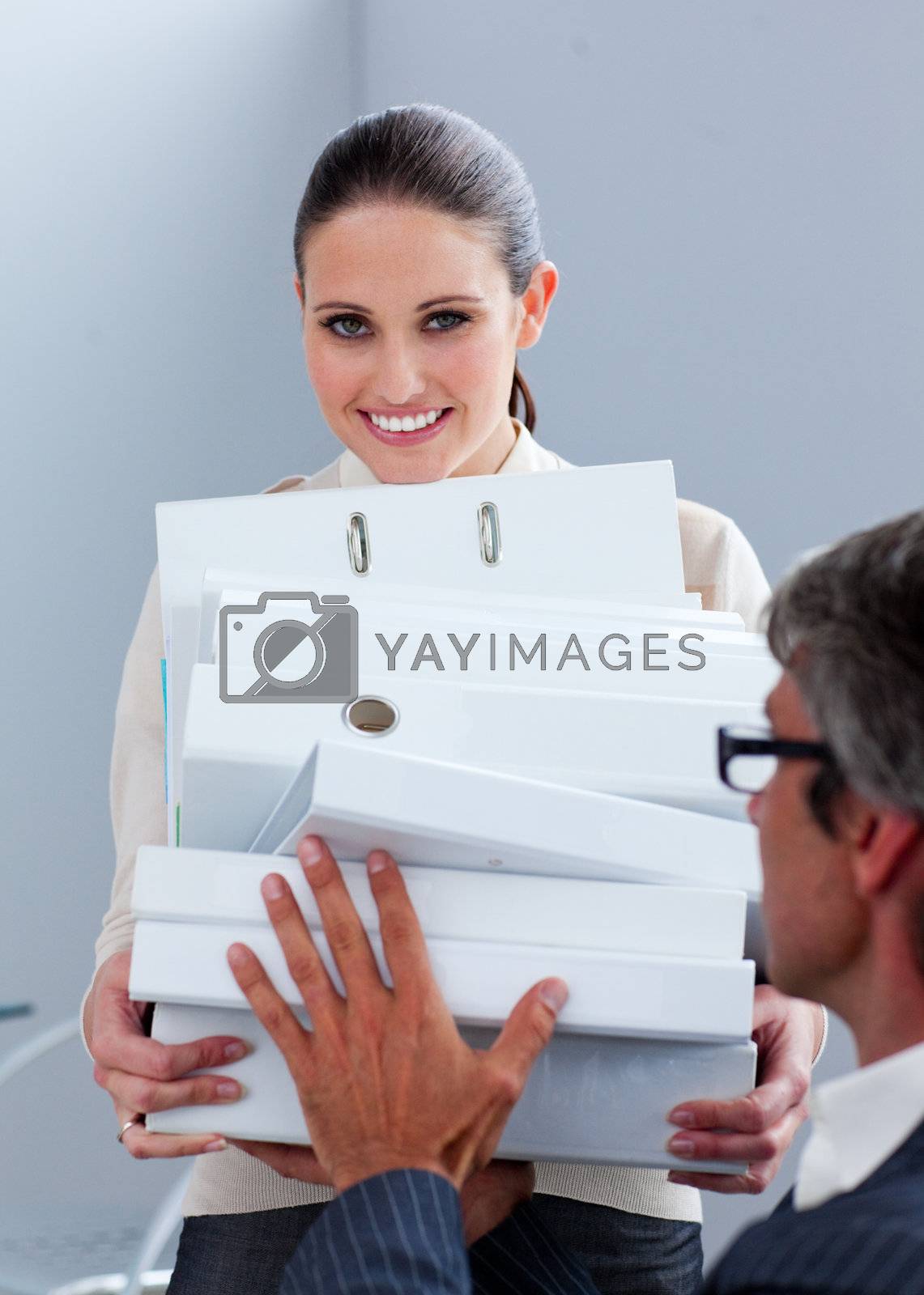 Royalty free image of Young businesswoman and her manager carrying a pile of folders by Wavebreakmedia