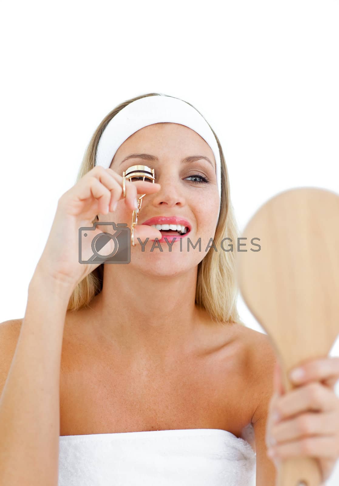 Royalty free image of Beautiful woman using an eyelash curler  by Wavebreakmedia