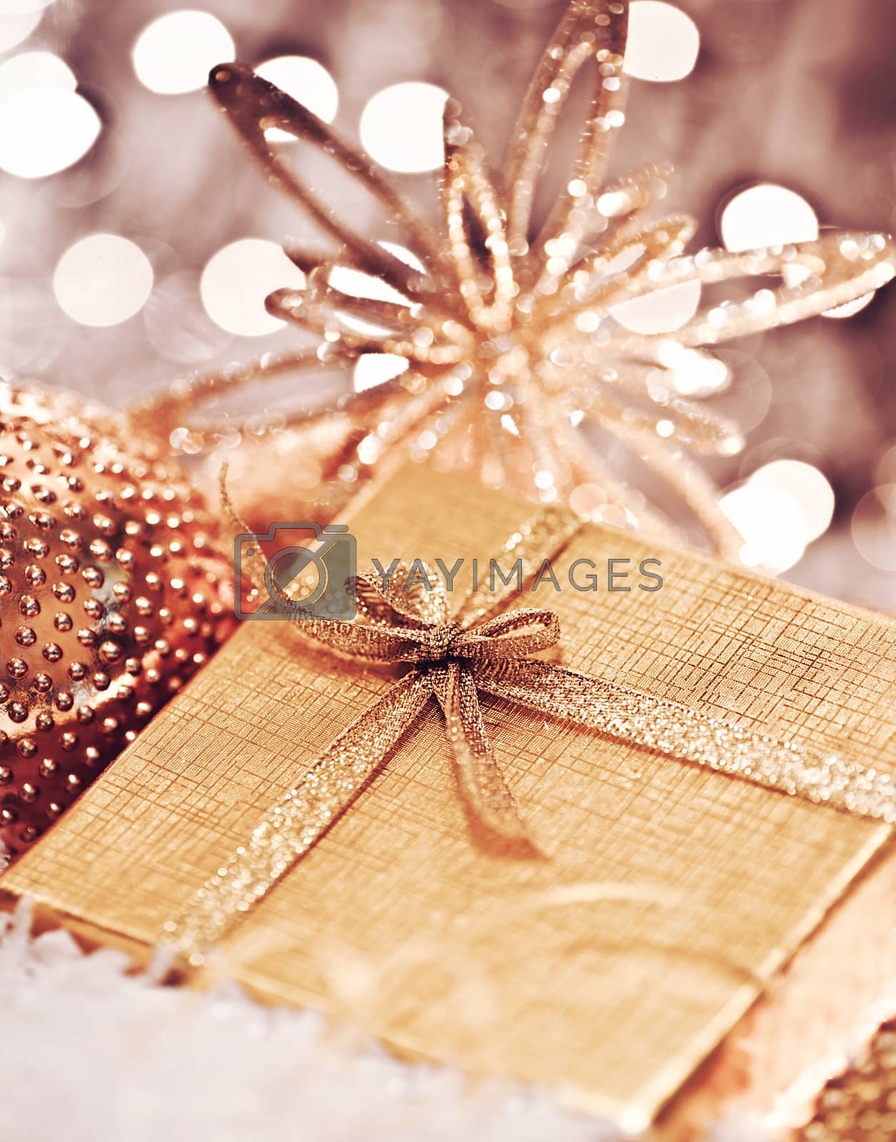 Royalty free image of Golden Christmas gift with baubles decorations by Anna_Omelchenko