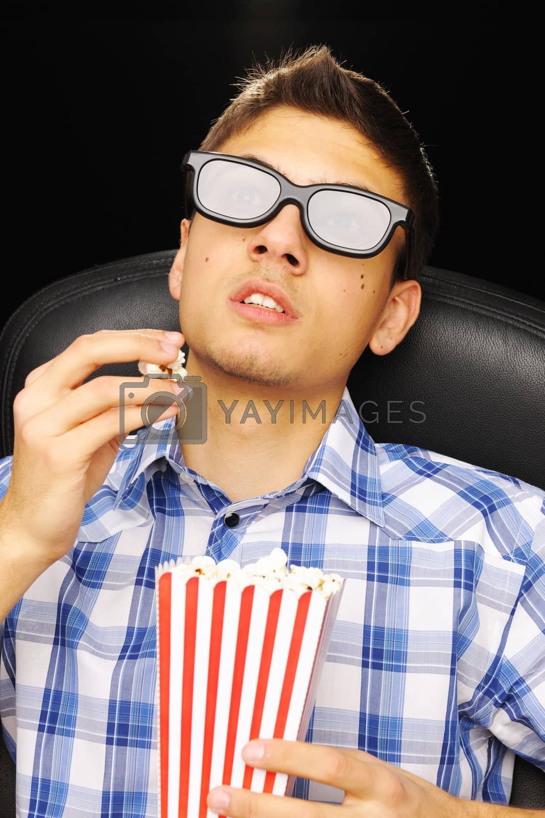 Royalty free image of Young man at cinema by haveseen