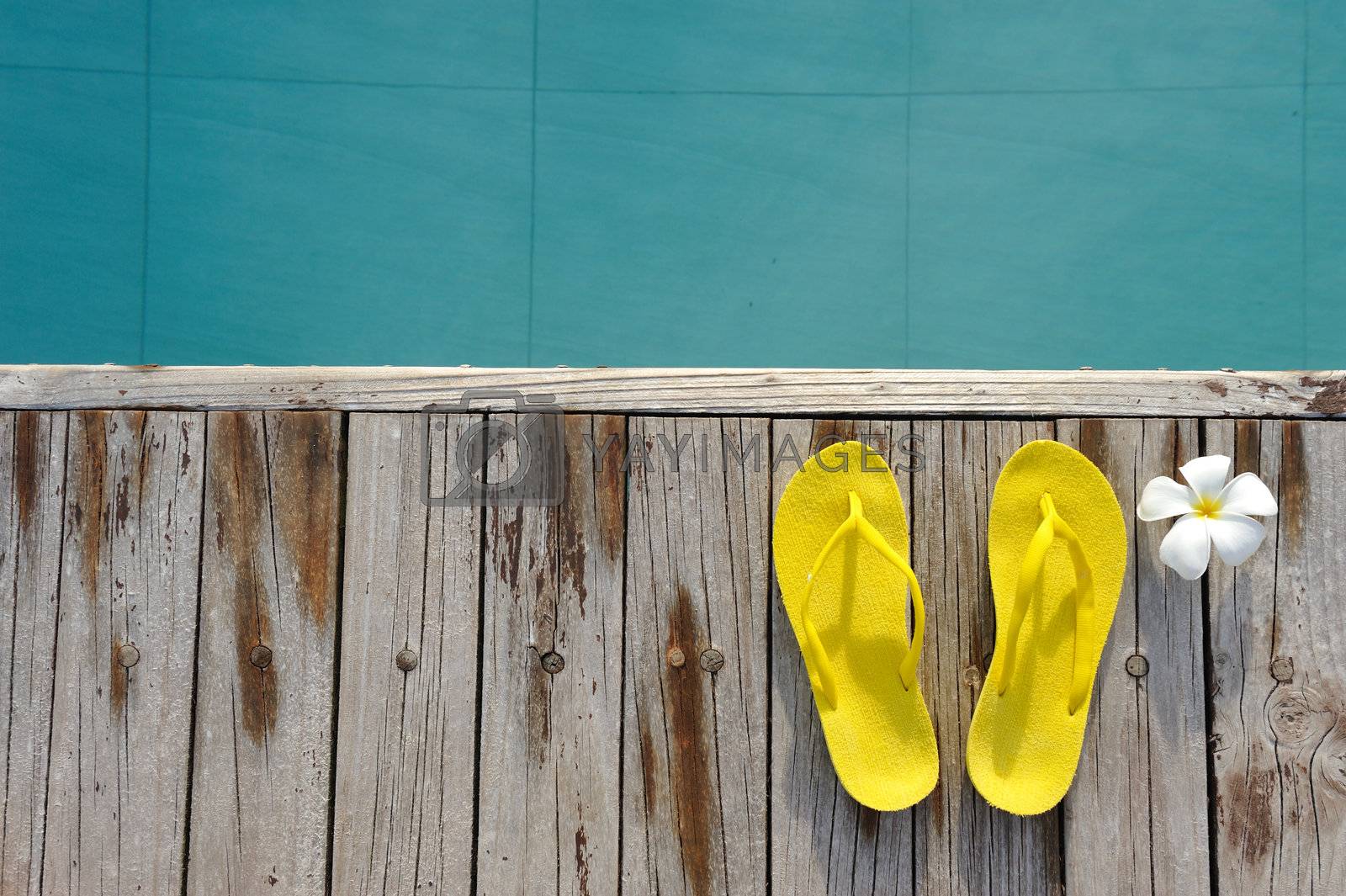 Royalty free image of Sandals by a swimming pool  by haveseen