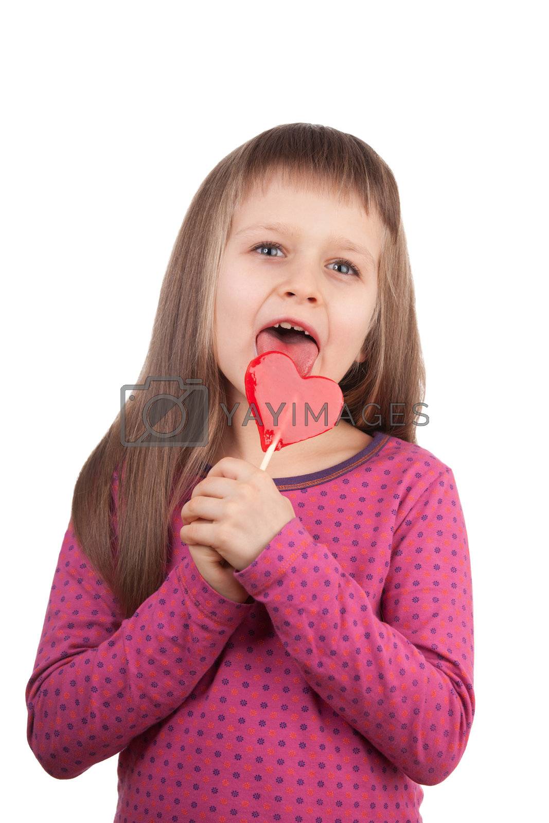 Royalty free image of Little girl 7-8 years old licking red heart lollipop isolated  by SergeyAK