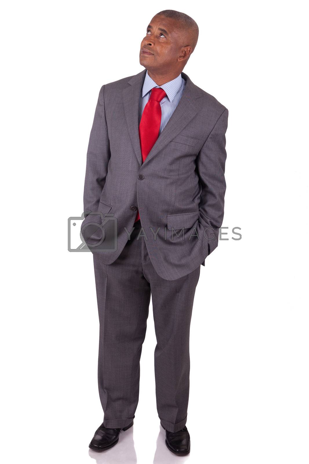 Royalty free image of American business man standing on white with hands in pocket by michel74100