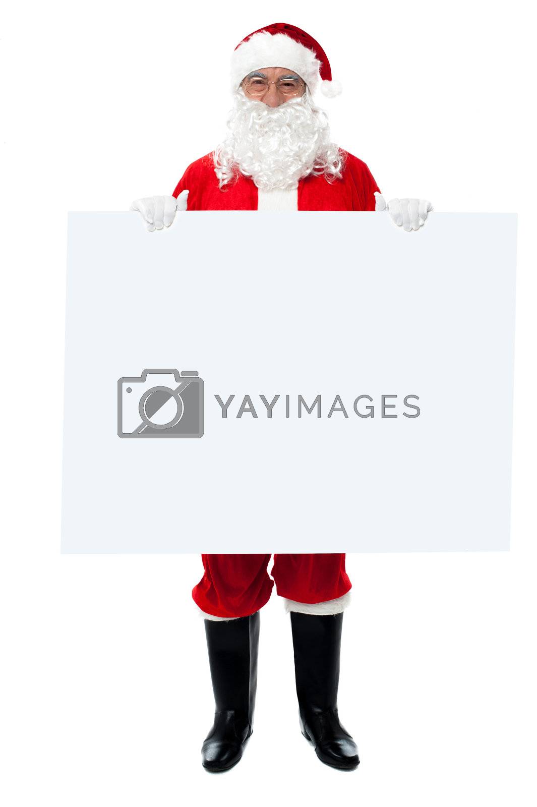 Royalty free image of Saint Nicholas standing behind blank whiteboard by stockyimages